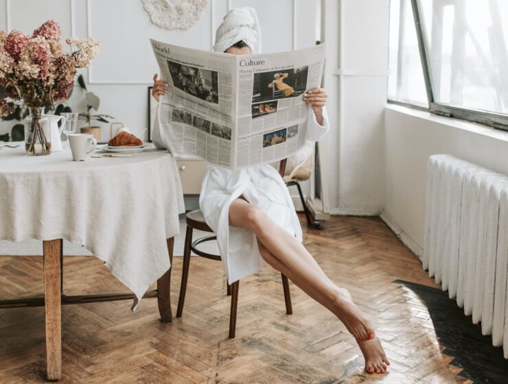 Klara Lukavski, woman in white robe sitting on a chair while reading