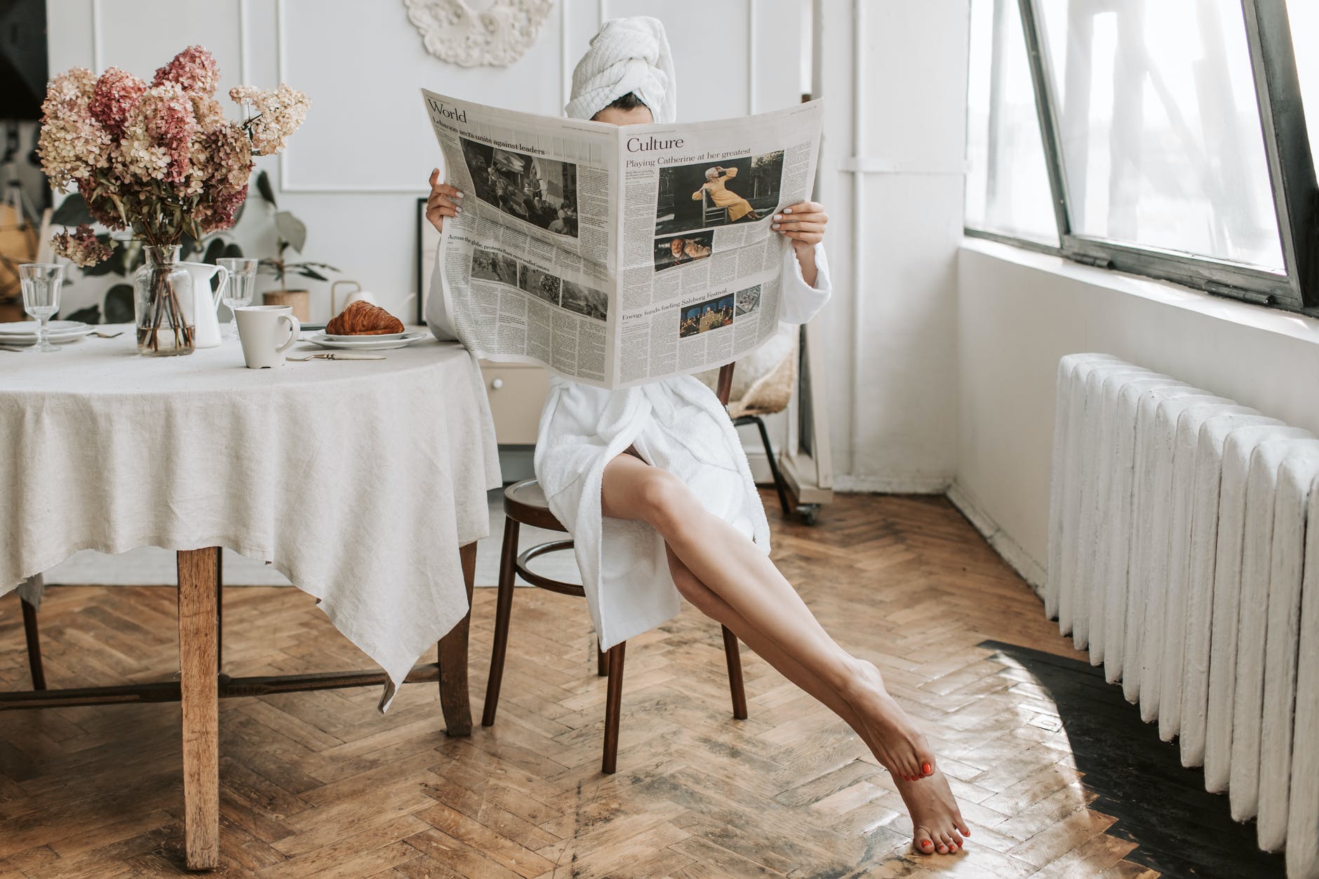 tko si ti,

woman in white robe sitting on a chair while reading