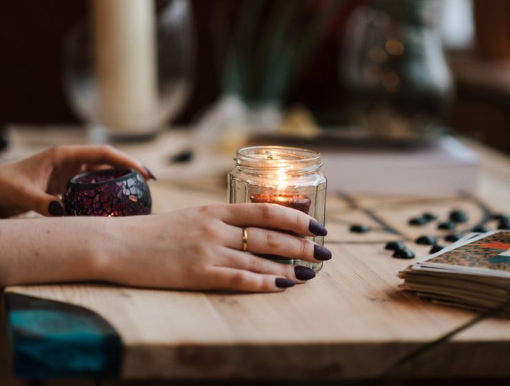 tarot i zodijak, faceless fortune teller with burning candles at home
