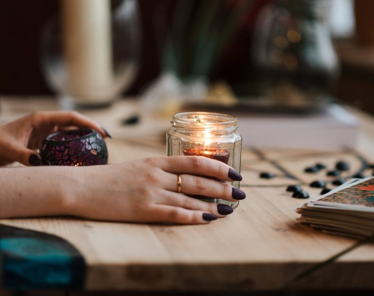 tarot i zodijak, faceless fortune teller with burning candles at home