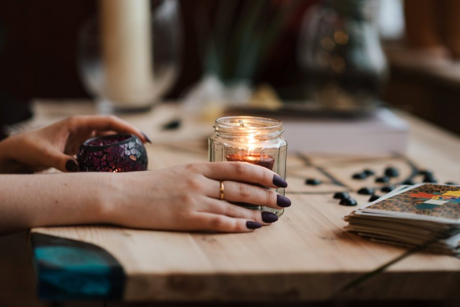 tarot i zodijak, faceless fortune teller with burning candles at home