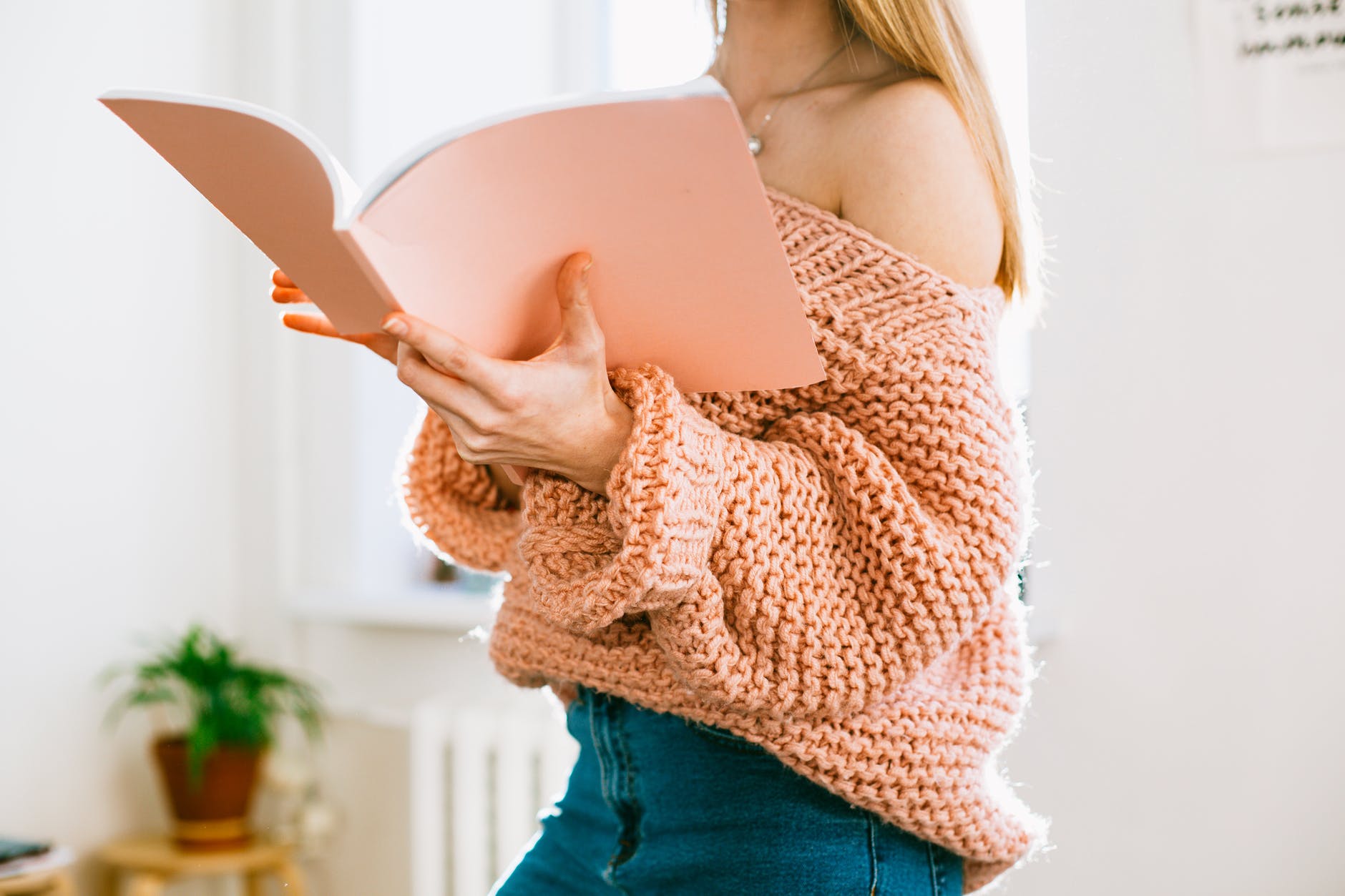 young woman reading book at home