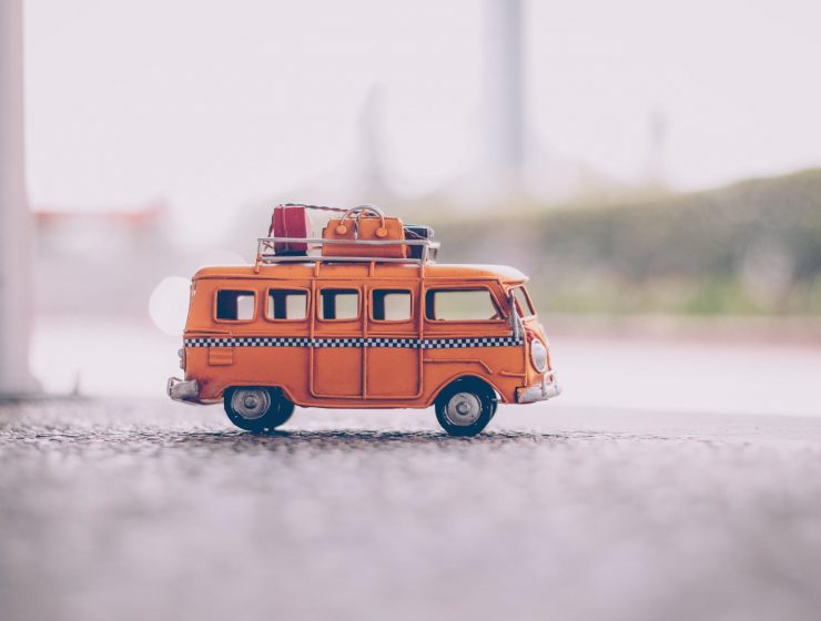 putovanja, orange van die cast model on pavement