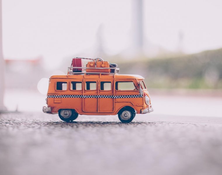 putovanja, orange van die cast model on pavement