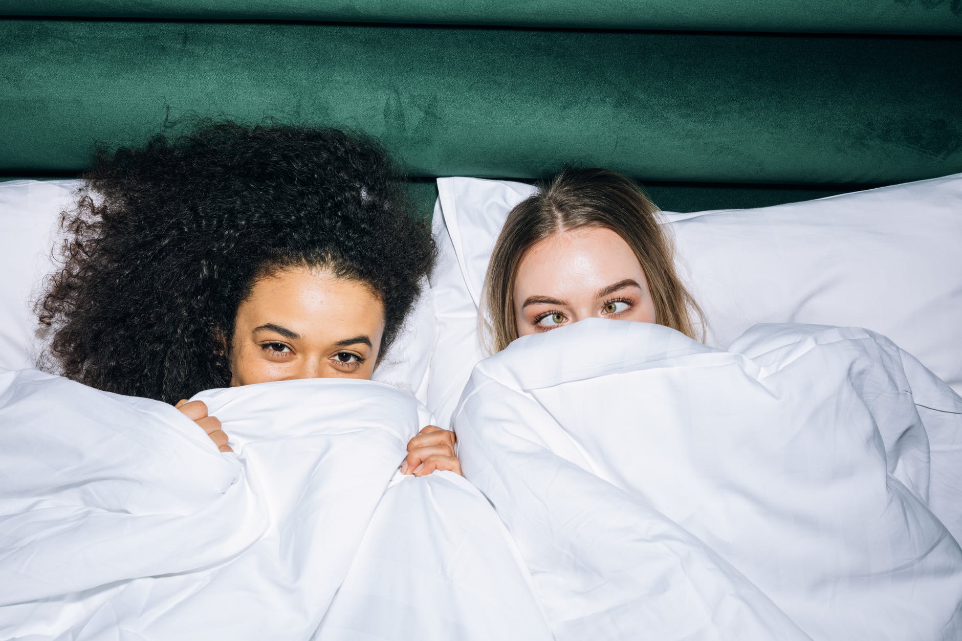 prijateljstva, two young girls lying on white bed