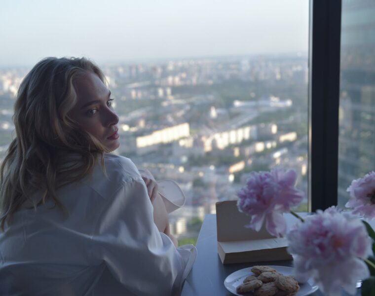 general, woman looking back on flowers