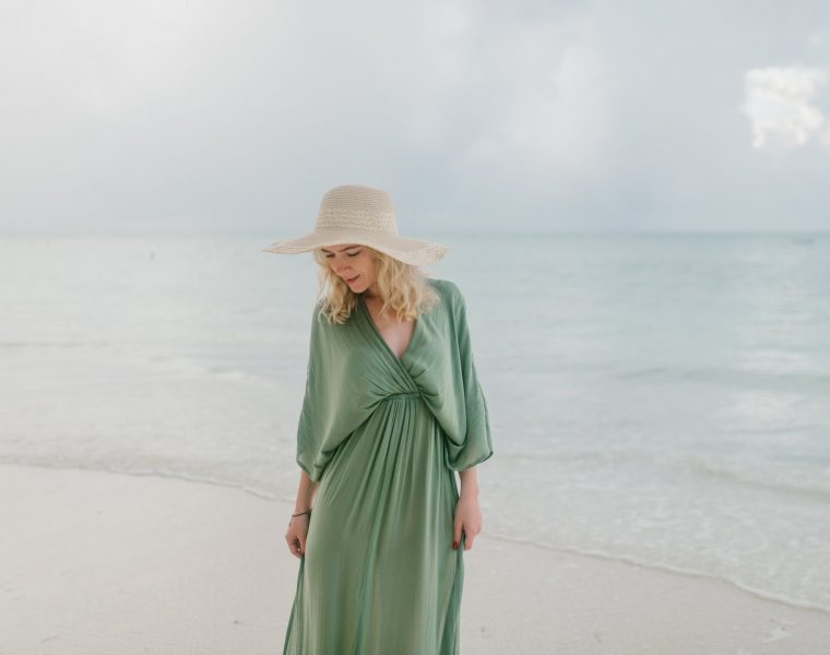 U što najmanje ulažemo, gentle woman in dress standing on wet sandy seacoast