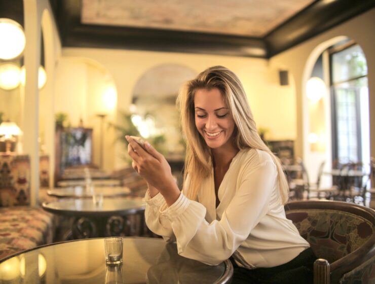 šarm, cheerful female having drink in elegant bar
