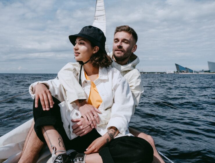 Duhovno i materijalno, man in white dress shirt and woman in white dress shirt sitting on boat