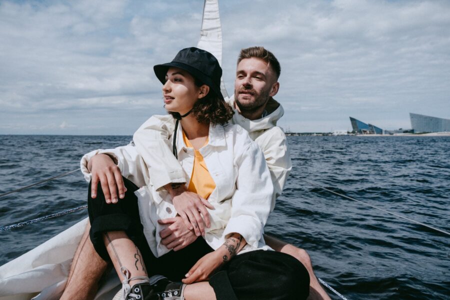 Duhovno i materijalno, man in white dress shirt and woman in white dress shirt sitting on boat