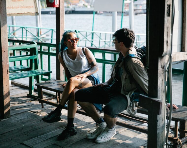 Poze, man and woman sitting on wooden bench
