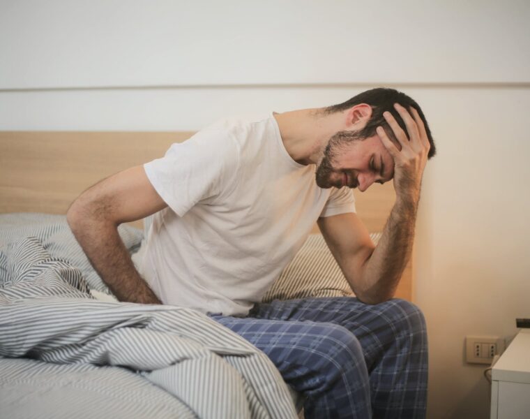 Moj Tvrtko je bolestan, young man in sleepwear suffering from headache in morning