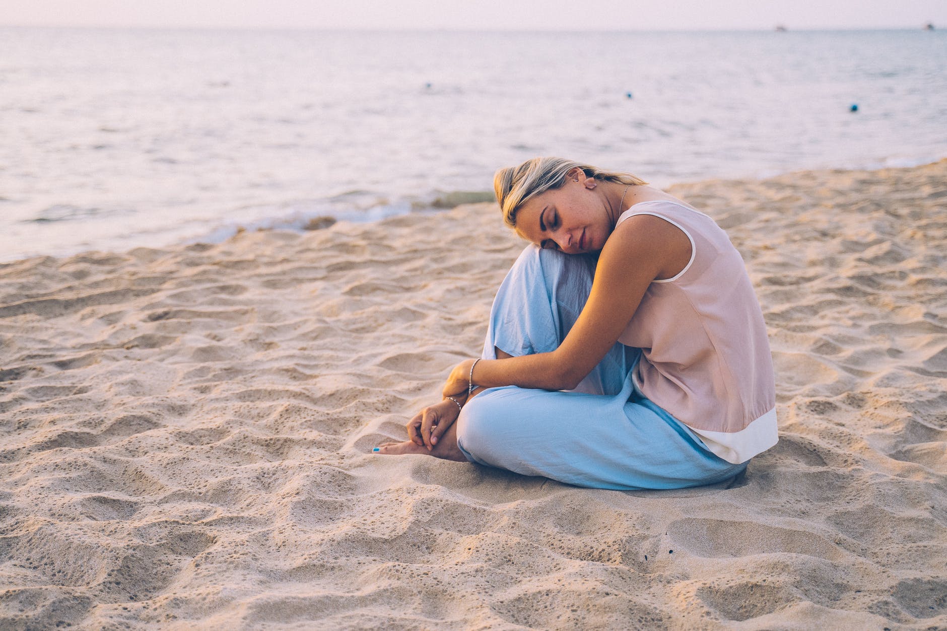 Show must go on
a blonde woman sitting on a brown sand
