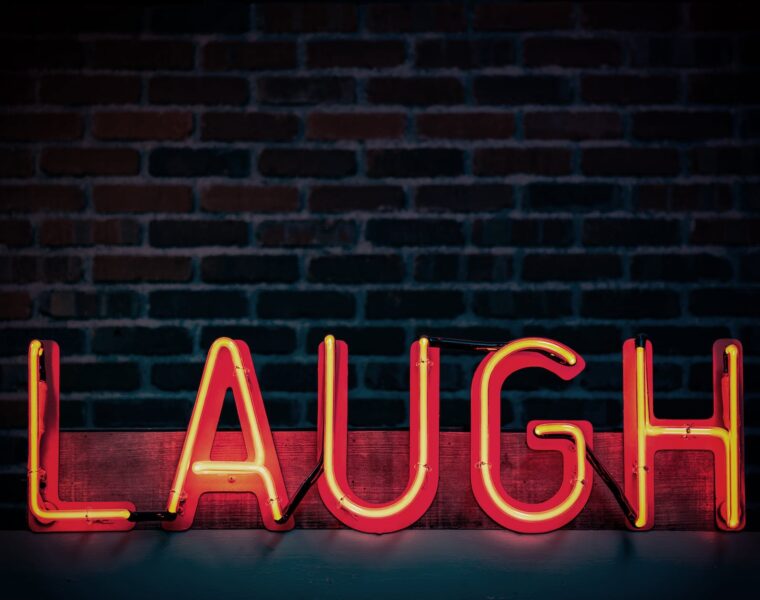 zajebancija, laugh neon light signage turned on